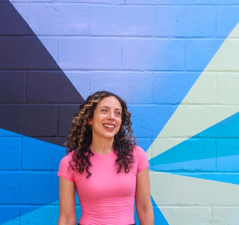 Stephanie Boutari in front of colourful wall mural