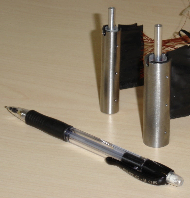 Pen next to the micro energy harvesters to show size
