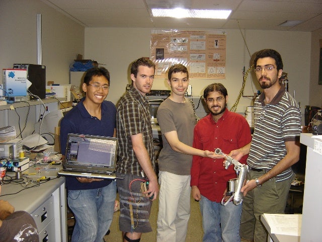 Students who created the product posing with the machine