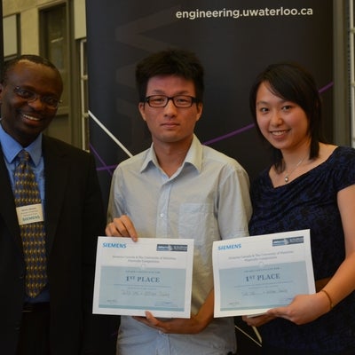 Burshu Nkwawir presents William Truong and Sally Lee with their 1st prize certificates