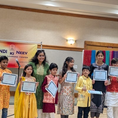 Ripple awarding her Hindi-school students on their year-end achievements
