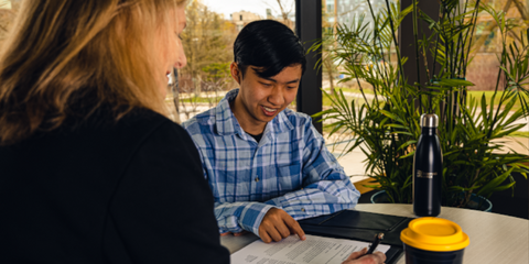 Student reviewing resume with employer