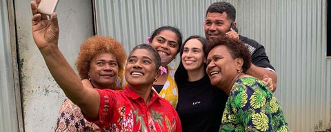 A group of locals from Suva, Fiji gather together for a group selfie with MPACS graduate student Rafaella