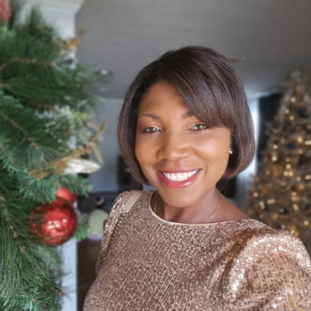 Woman smiling by Christmas decorations indoors