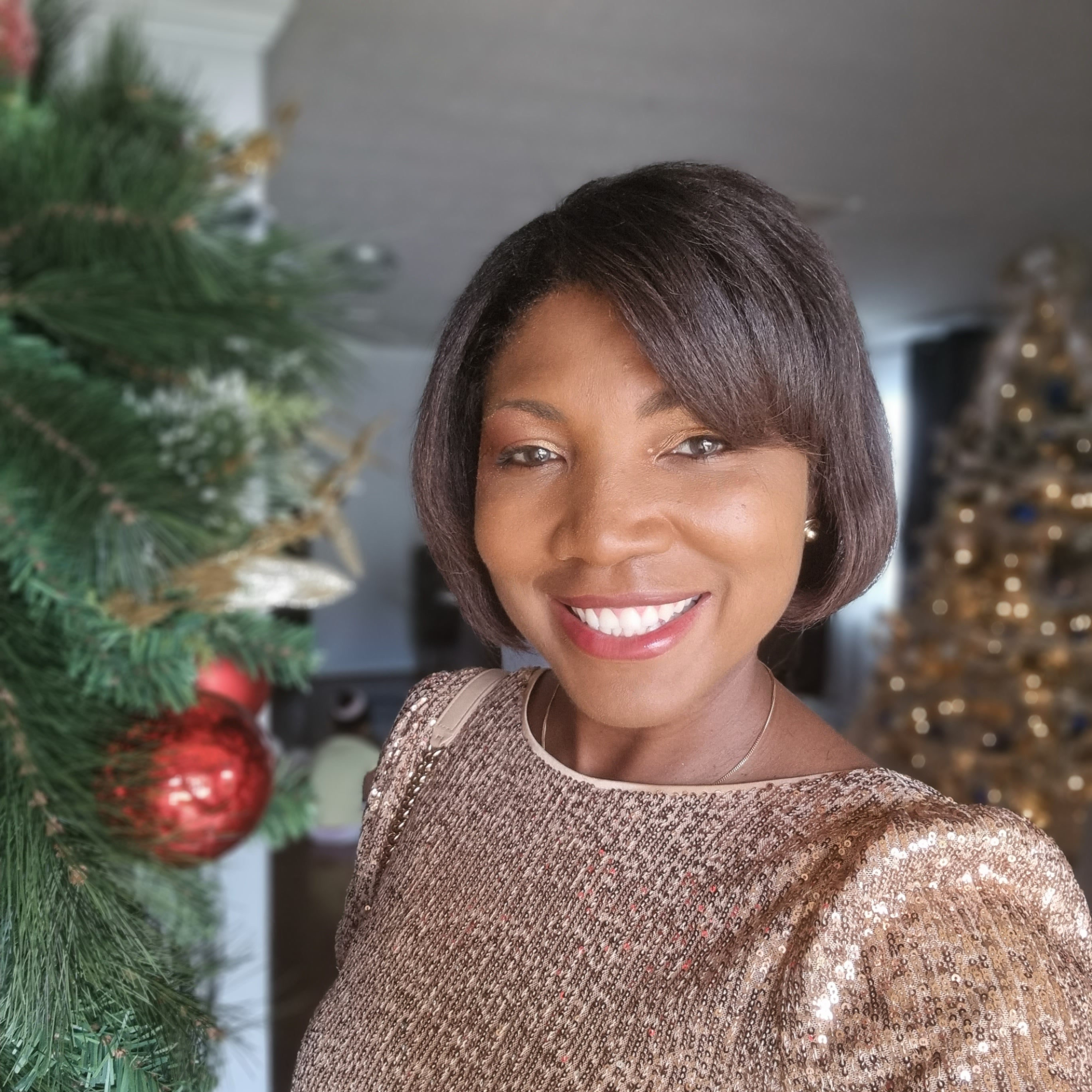 Woman smiling by Christmas decorations indoors