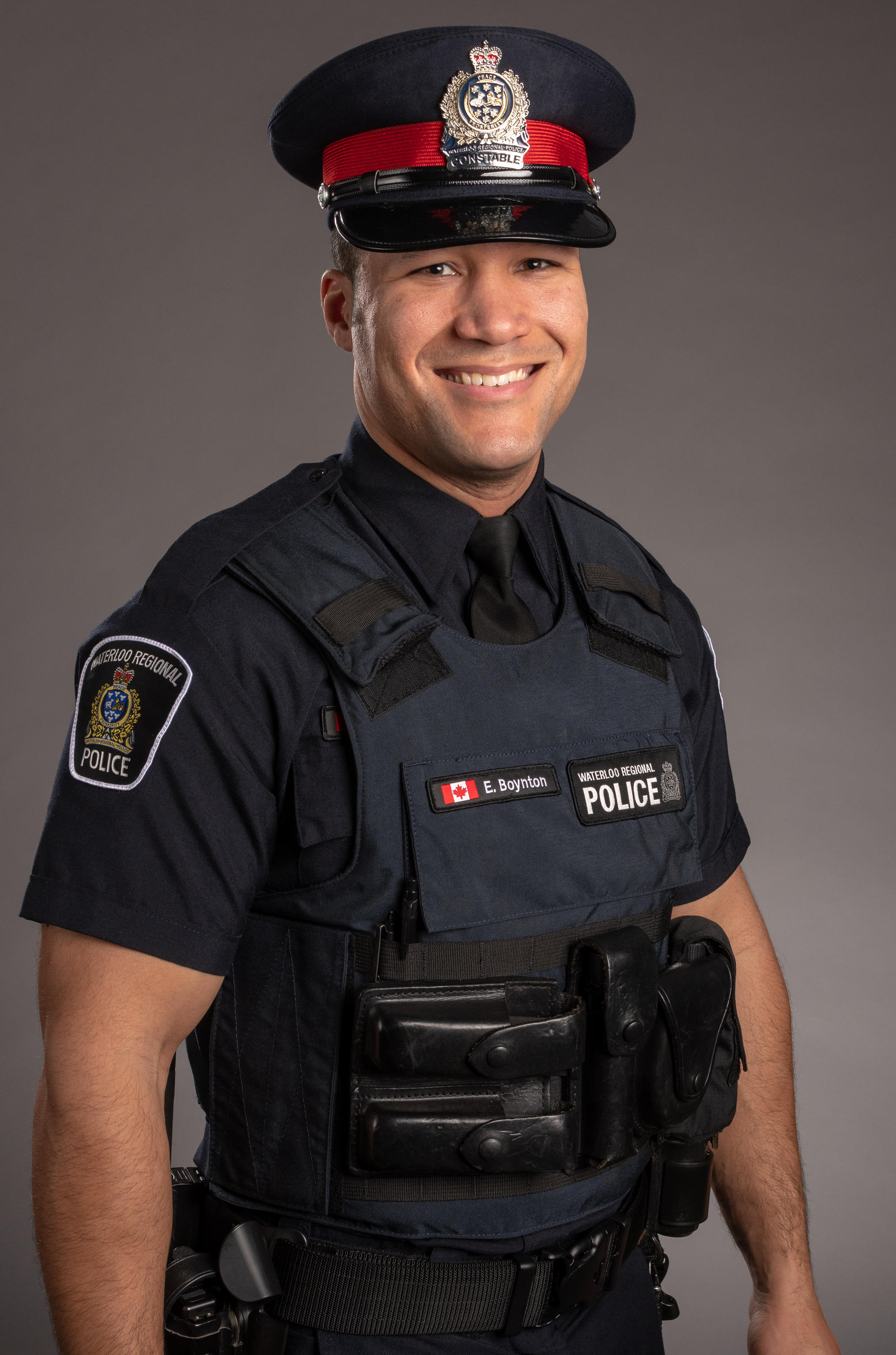 Cst. Eric Boynton's headshot. He is wearing his uniform and smiling into the camera.