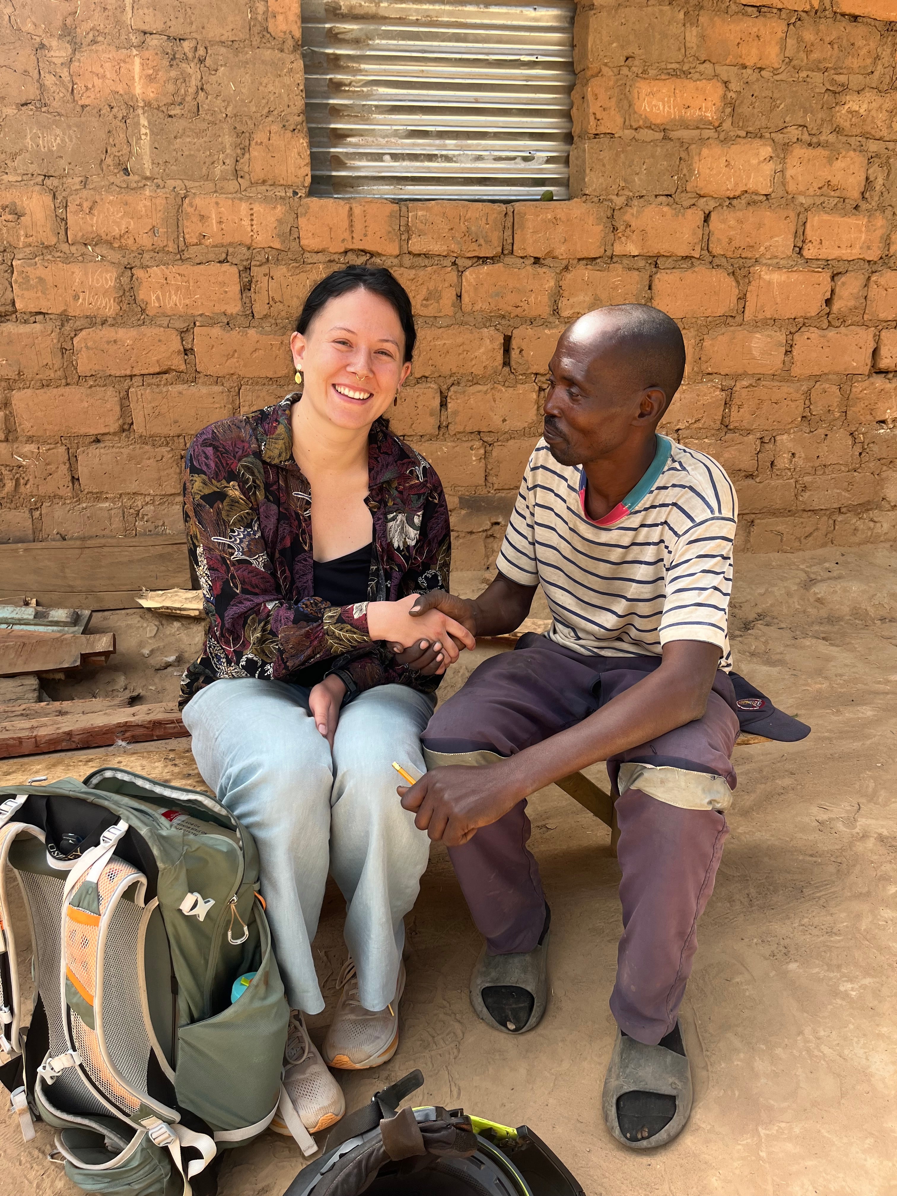 Picture of Emilie shaking hands with a local person in Zambia