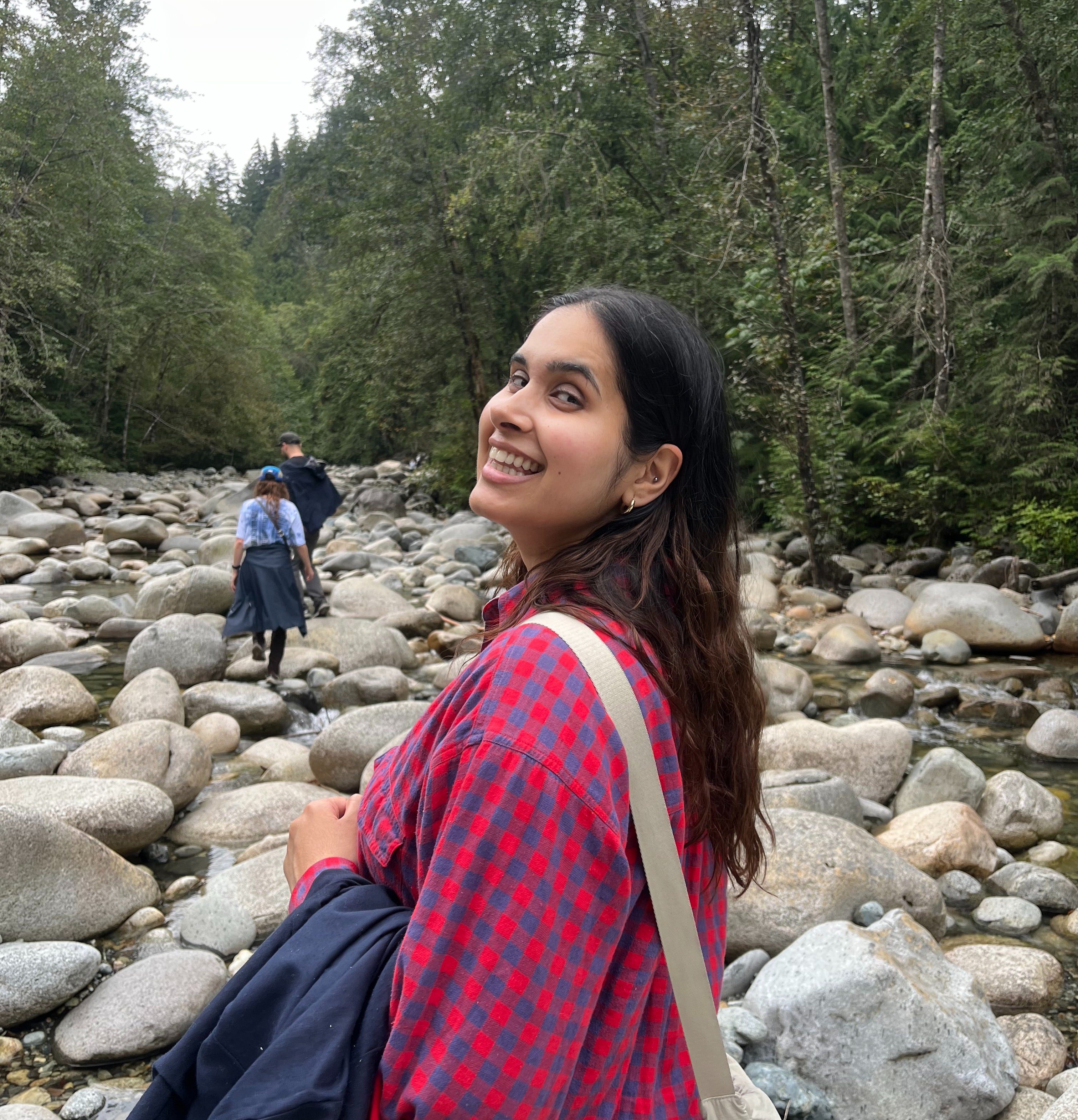 Woman smiling and walking through forest