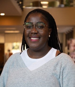 Thubehlile is smiling in a professional setting