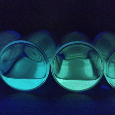 Close up of vibrant blue and green quantum dots under UV/black light