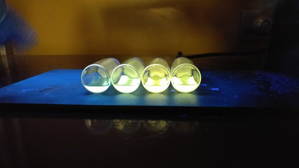 Zoomed out image of blue and yellow quantum dots under UV/black light