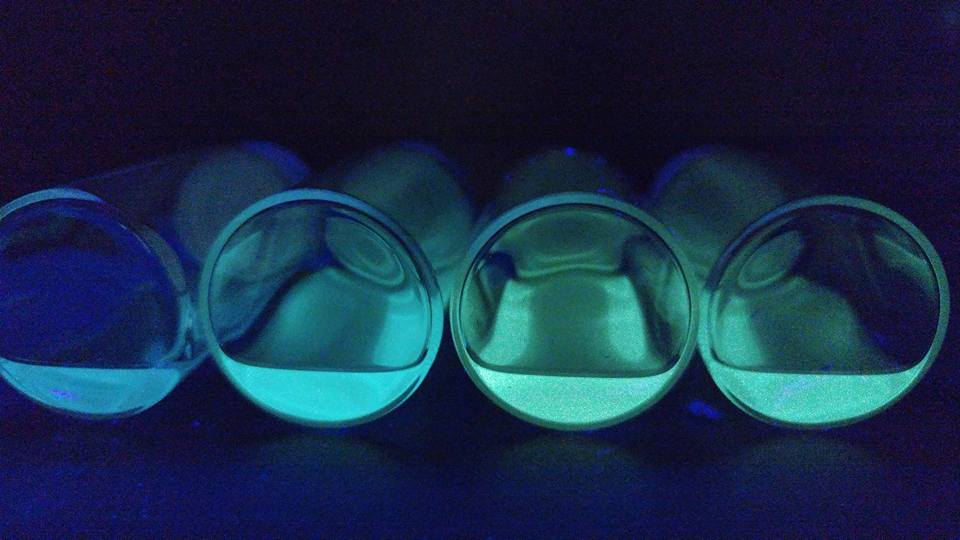 Close up of vibrant blue and green quantum dots under UV/black light