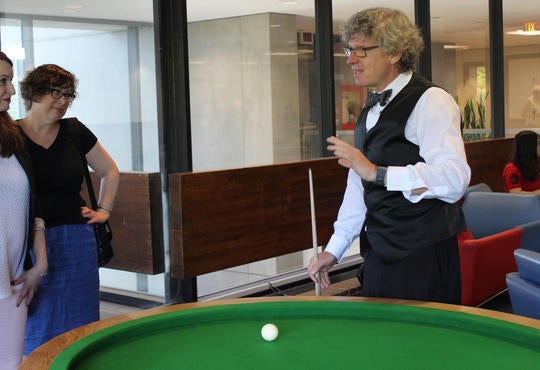 Dean Watt and a student unveil the elliptical pool table