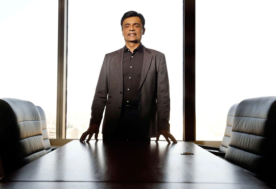 Rudy Karsan standing in an empty boardroom