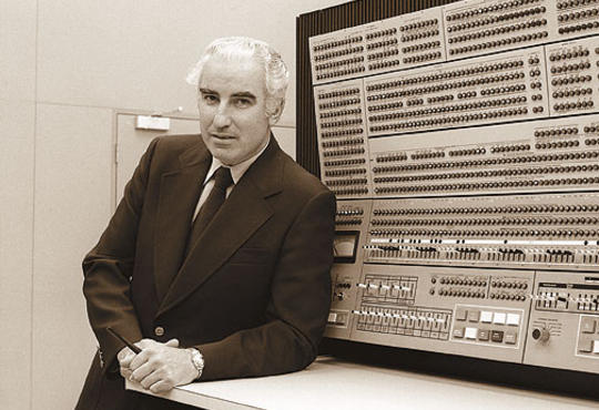 Wes Graham poses with one of Waterloo's original computers