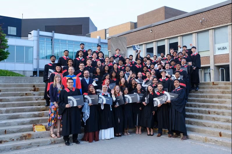 group of people standing on steps posing for a photo