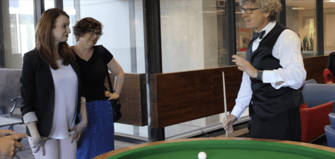 People talking while playing pool