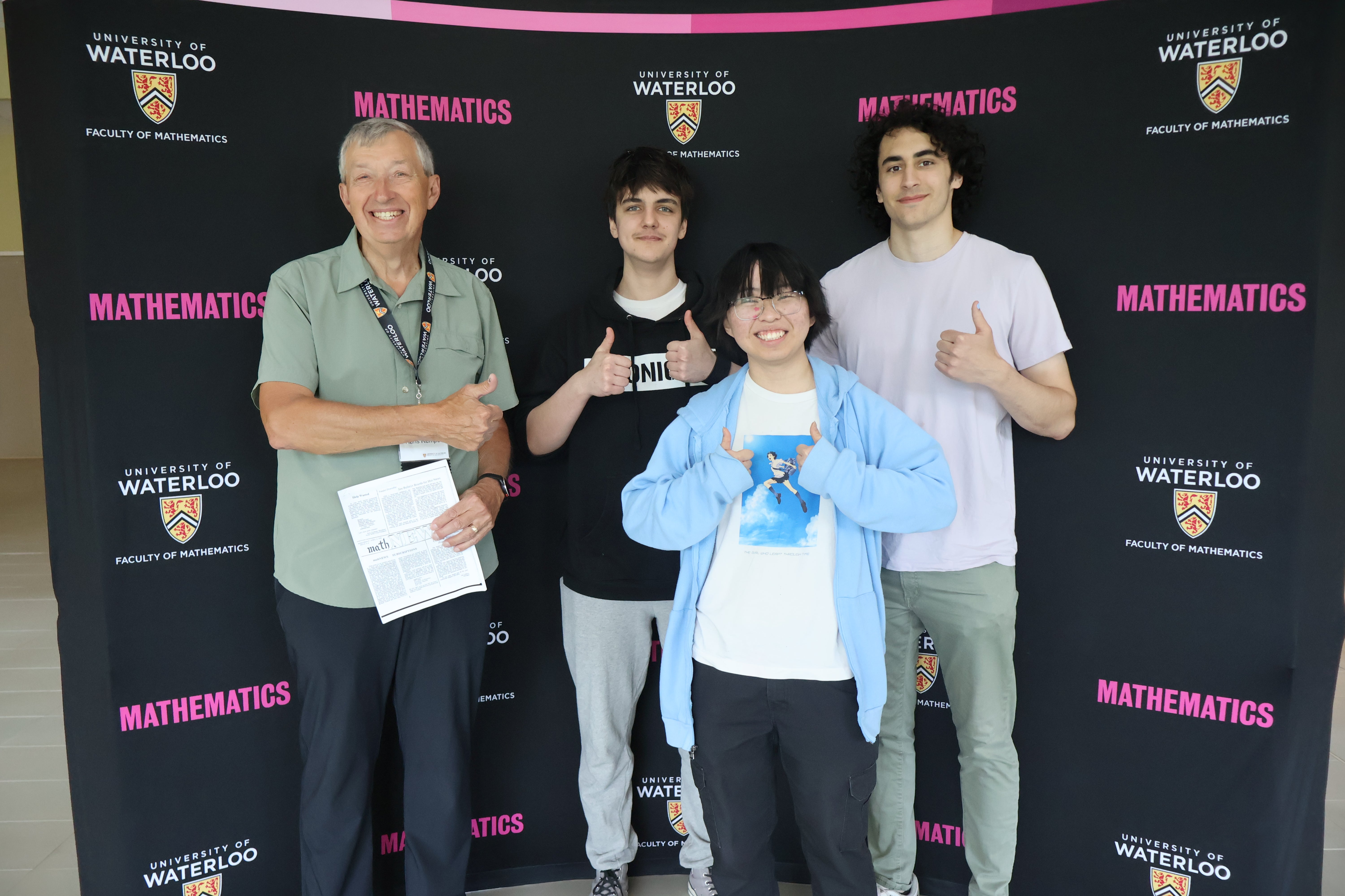 4 people with thumbs up smiling