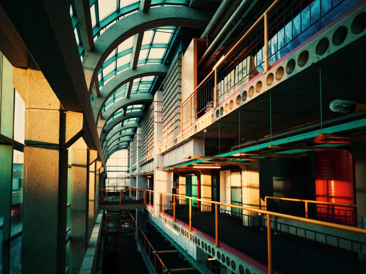 Inside of DC with glass overhead on the second floor with bright yellow railings
