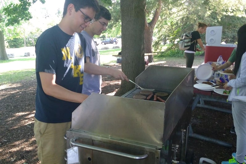 Two students barbecuing in the park