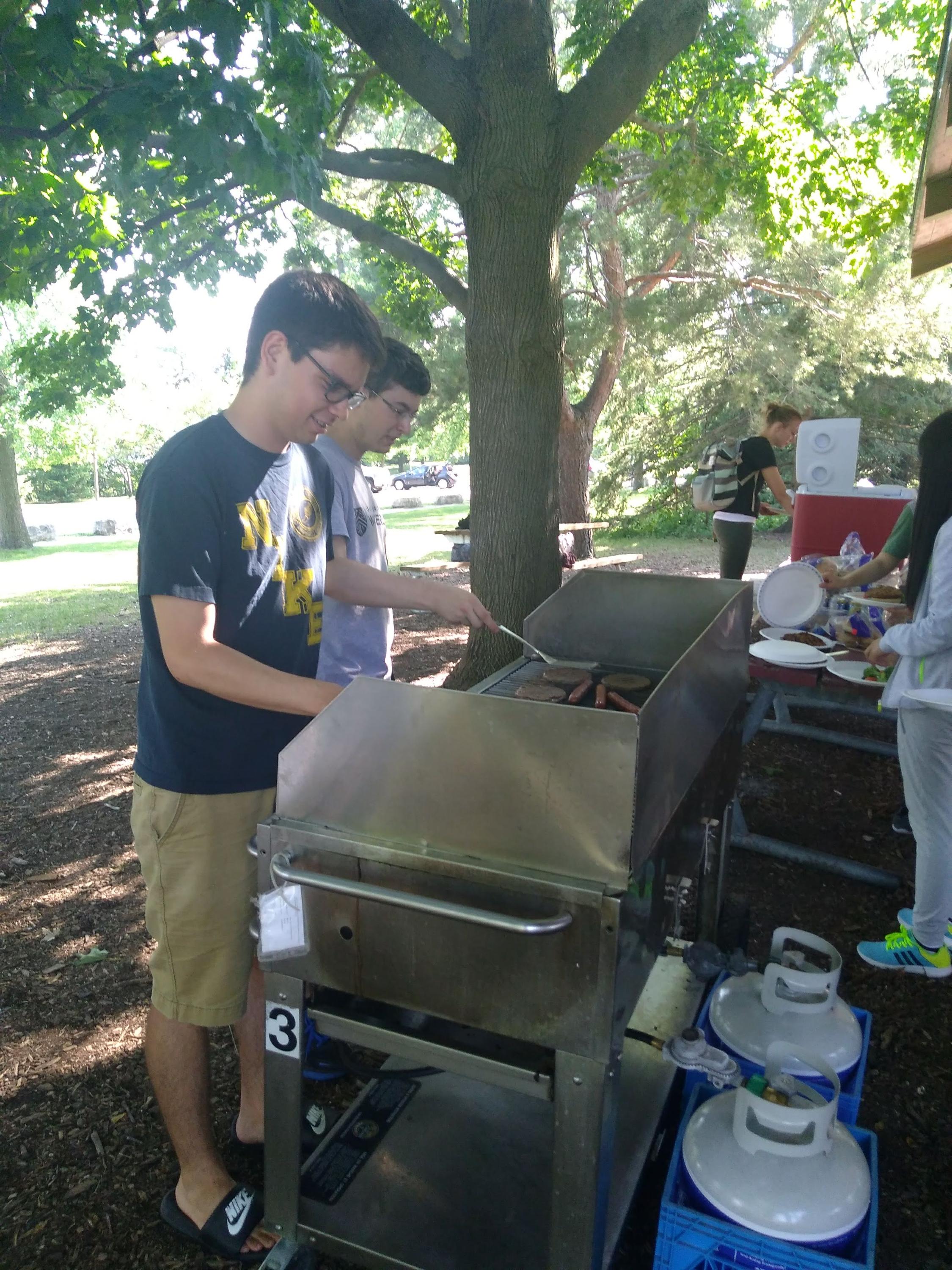 Two students barbecuing in the park