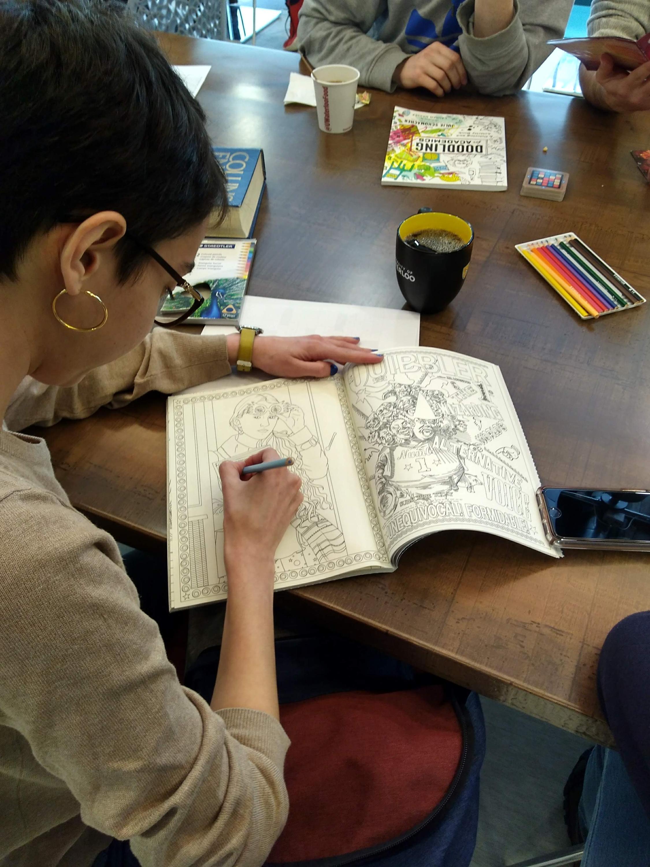 A student colouring in a picture in a colouring book.