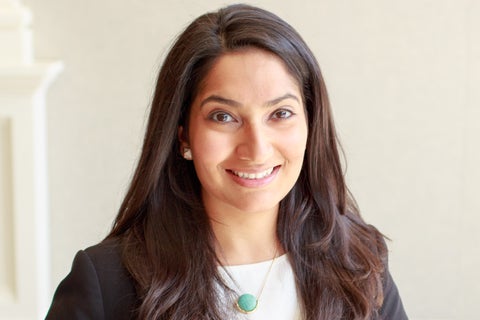 headshot of a women with long brown hair smiling