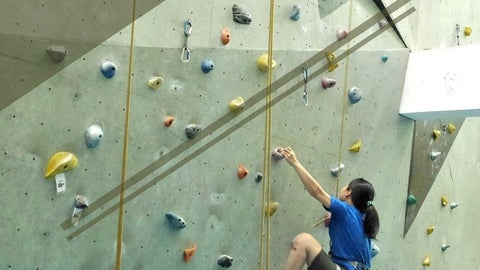 A woman on a rock climbing wall