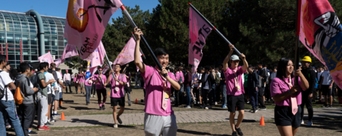 Faculty of Math students marching with pink flags at orientation