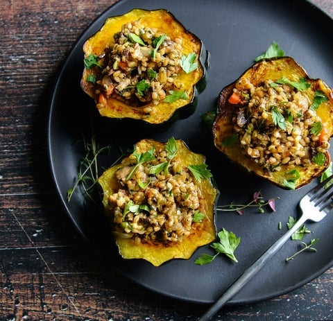 Stuffed, baked acorn with a meatless filling of wheatberries, walnuts, lentils, and veggies.