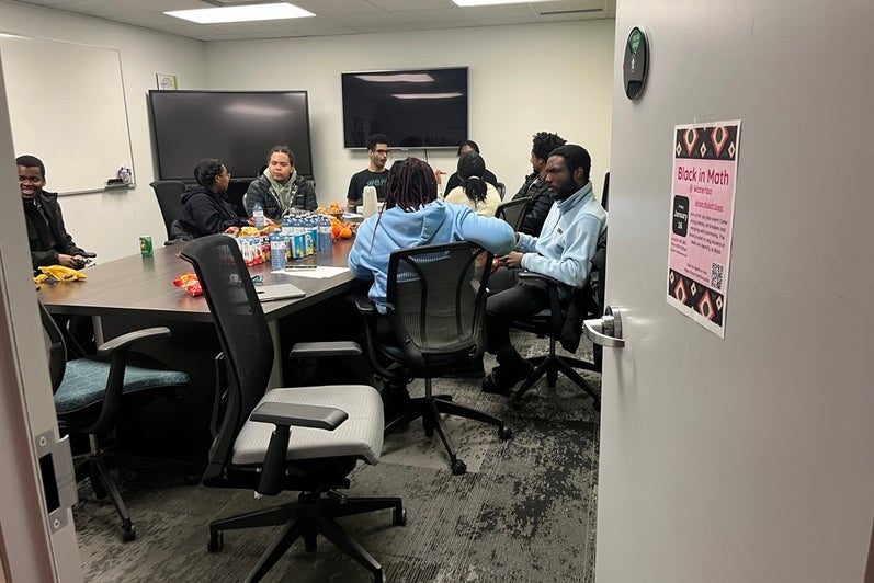 A group of people eating and talking to each other