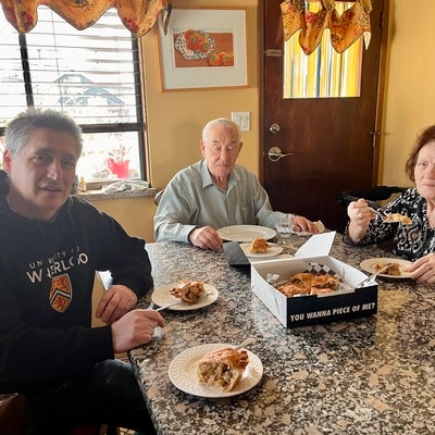 3 people sitting at a table eating pie