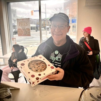 Man standing holding a pie