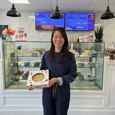 woman standing and smiling with pie