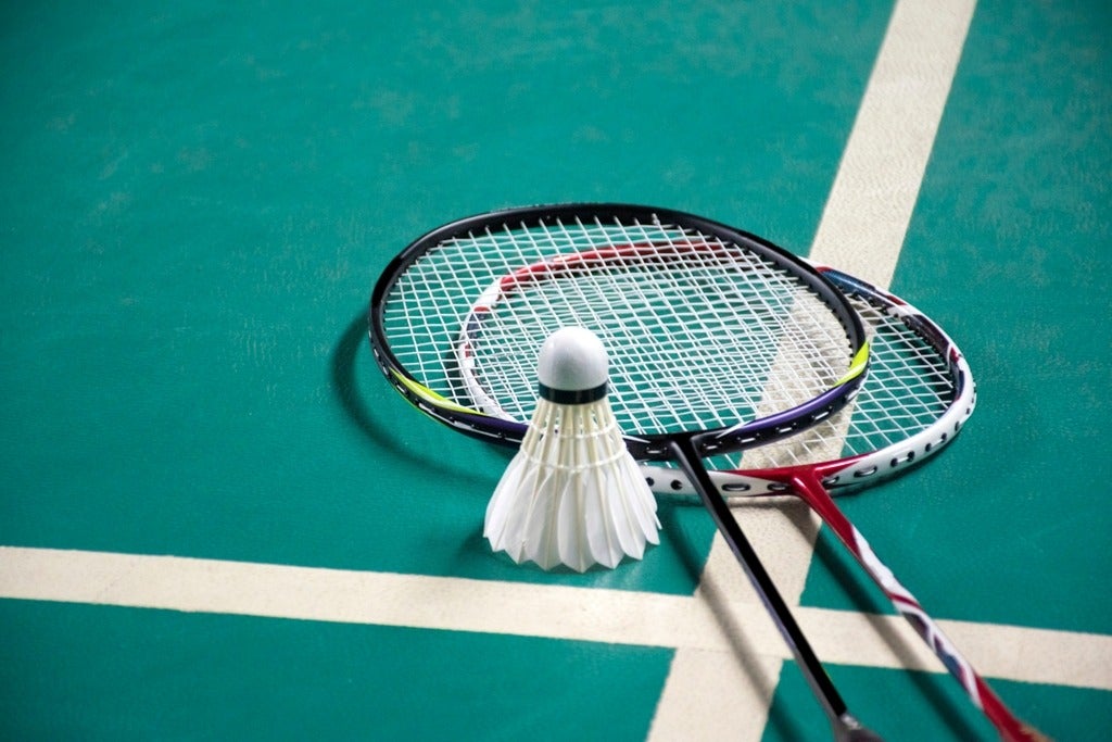 An image of two badminton racquets and a birdie