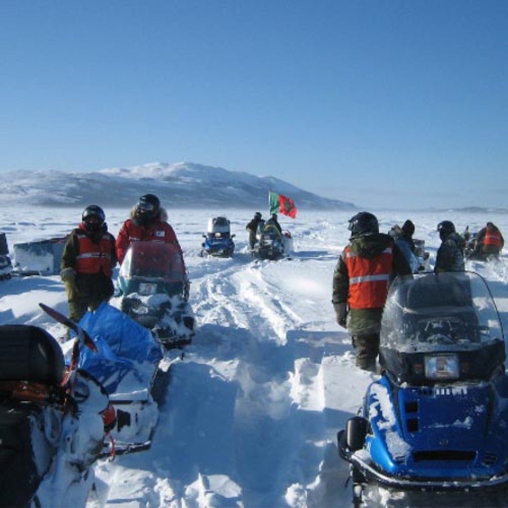 Reserach team on snowmobiles near Labrador