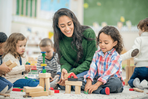 Daycare worker playing with children
