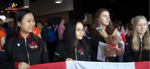 Canadian European Girls Math Olympiad team holding a Canadian flag