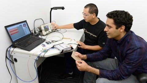 Wang and Abari demonstrate their Internet of Things hack at a computer. 
