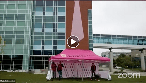 The OWeek team in the pink math tent in front of M3 with the pink tie hanging on the building