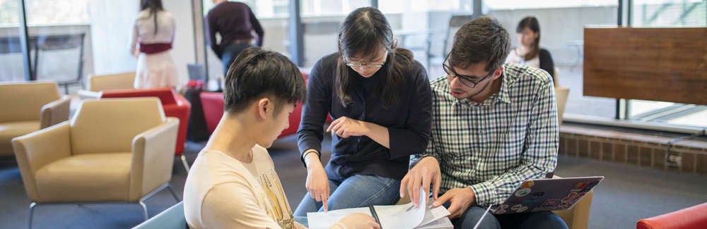 Graduate students working together in Math Comfy Lounge