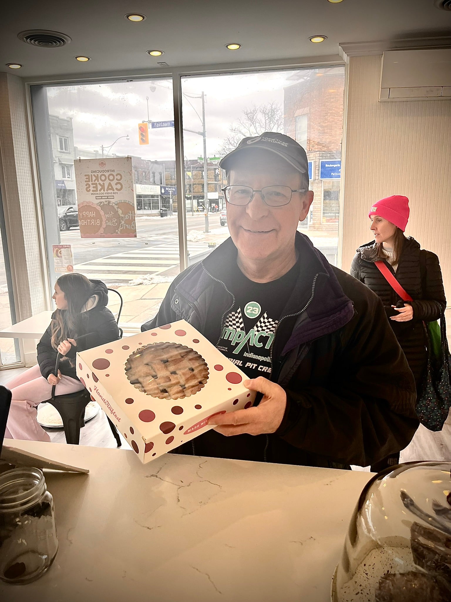 Man standing holding a pie