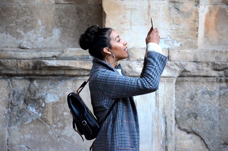 Female holding cellphone in the air 