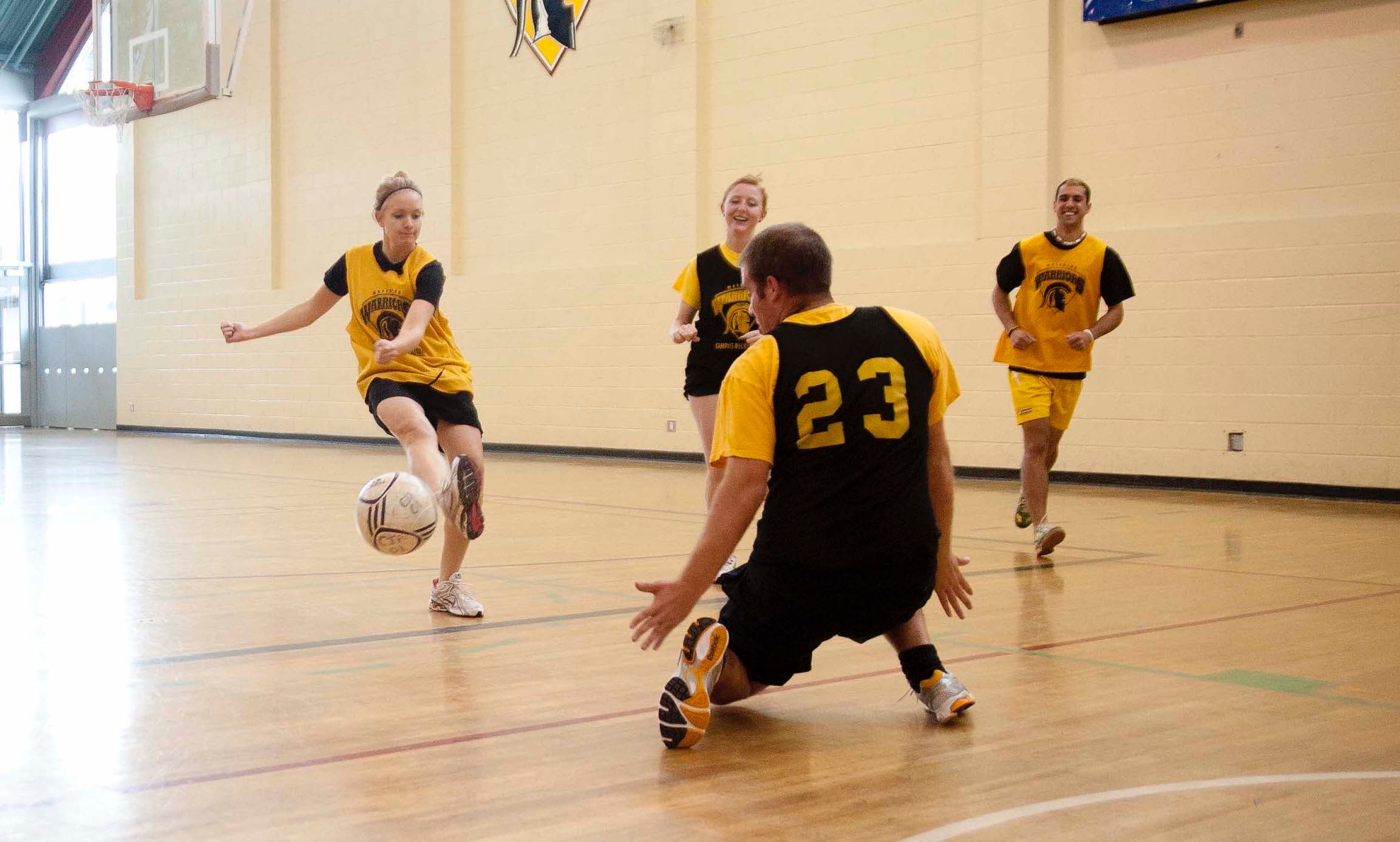 Students playing indoor soccer