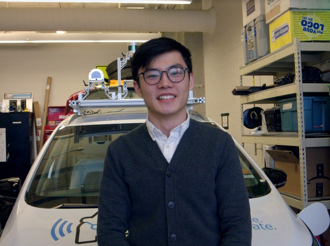 Ray Li pictured in front of the WATonomous vehicle.