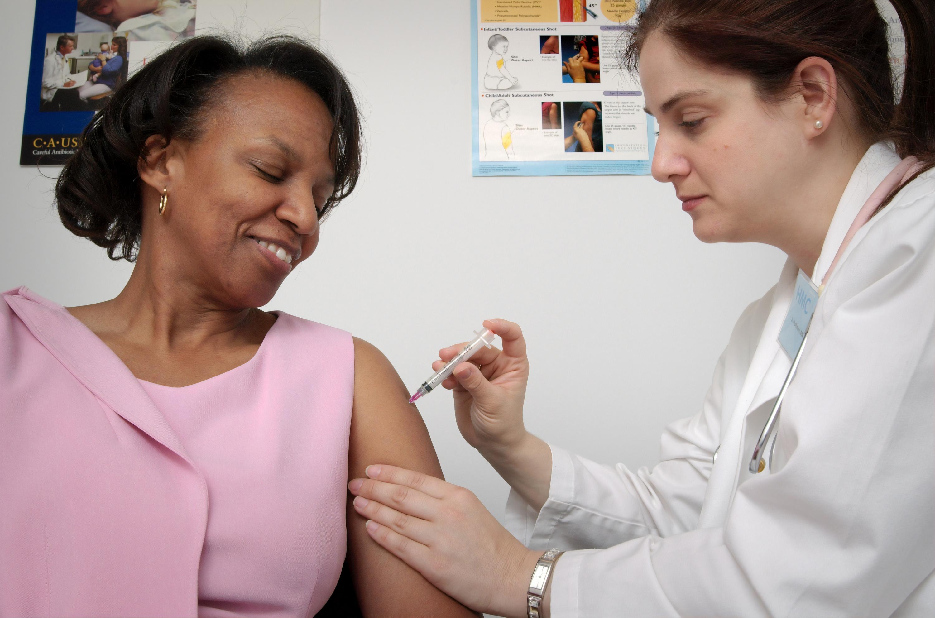 A doctor gives a patient a vaccine
