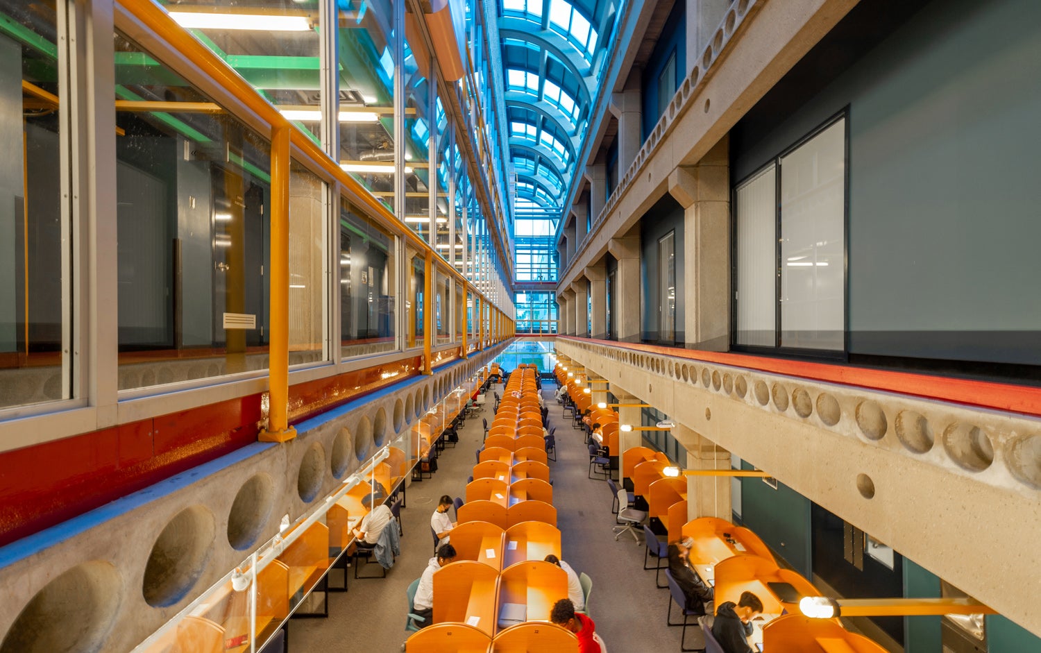 David Centre (a multi-story building with a glass roof and orange tables)