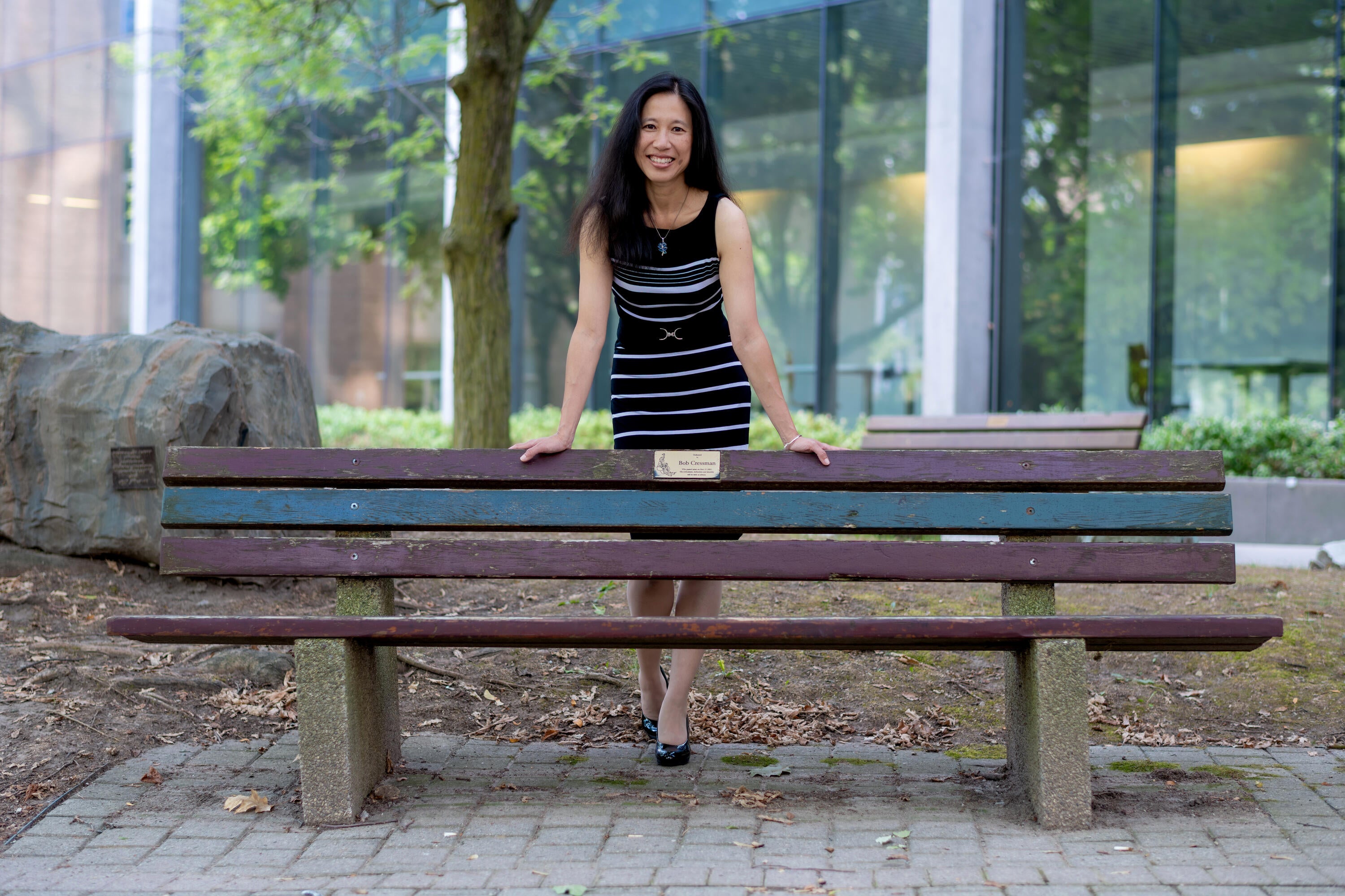 Anita Layton standing leaning on a bench