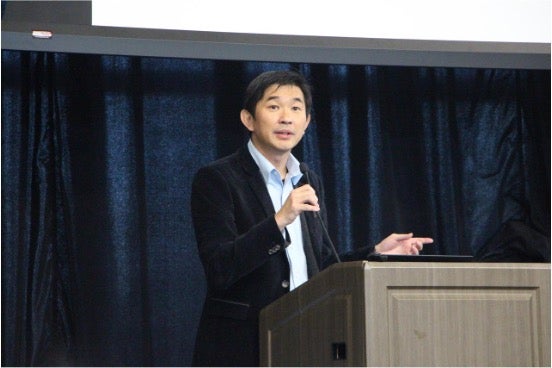 Ken Seng speaks at a podium