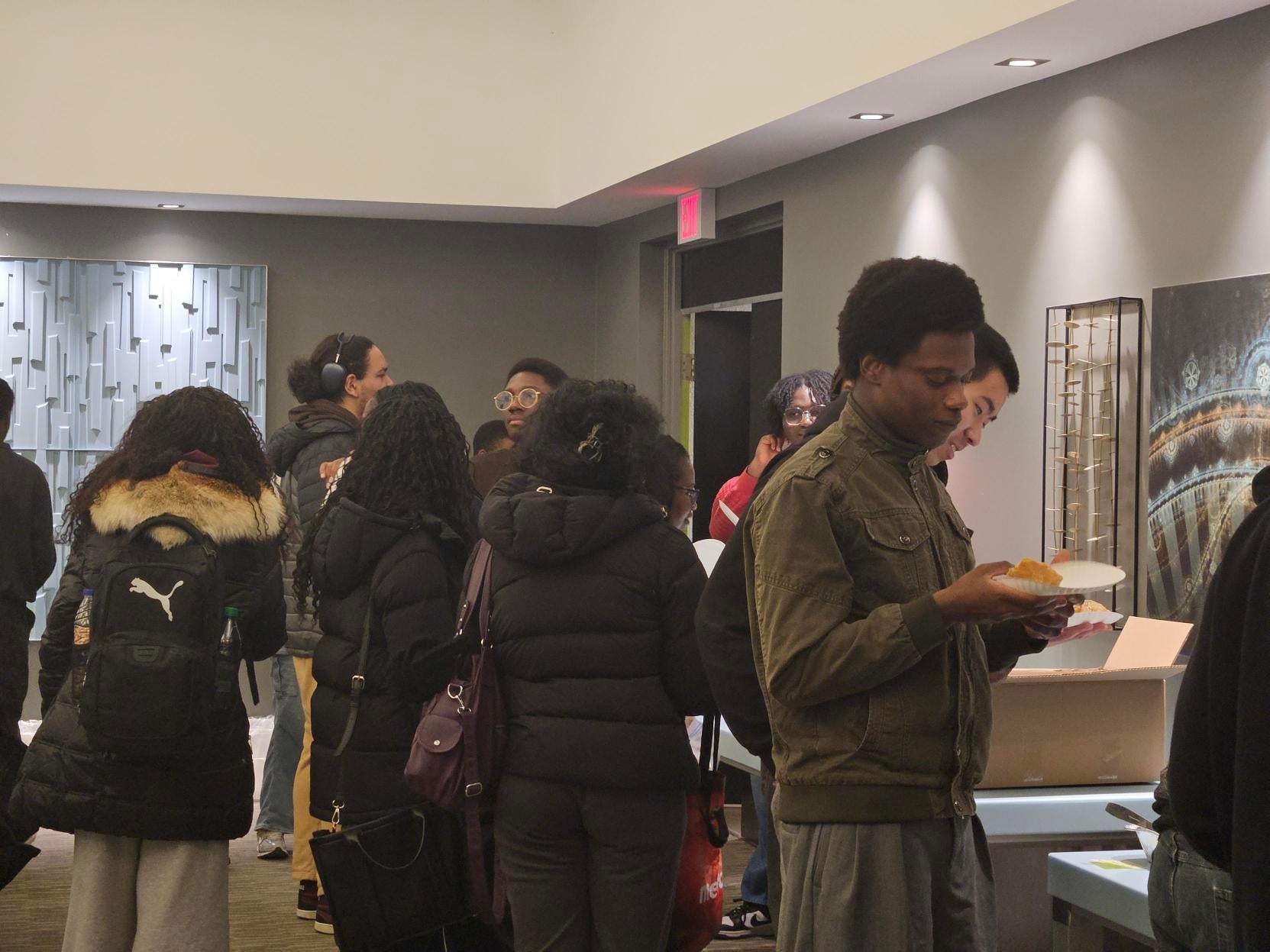People grabbing food and drinks